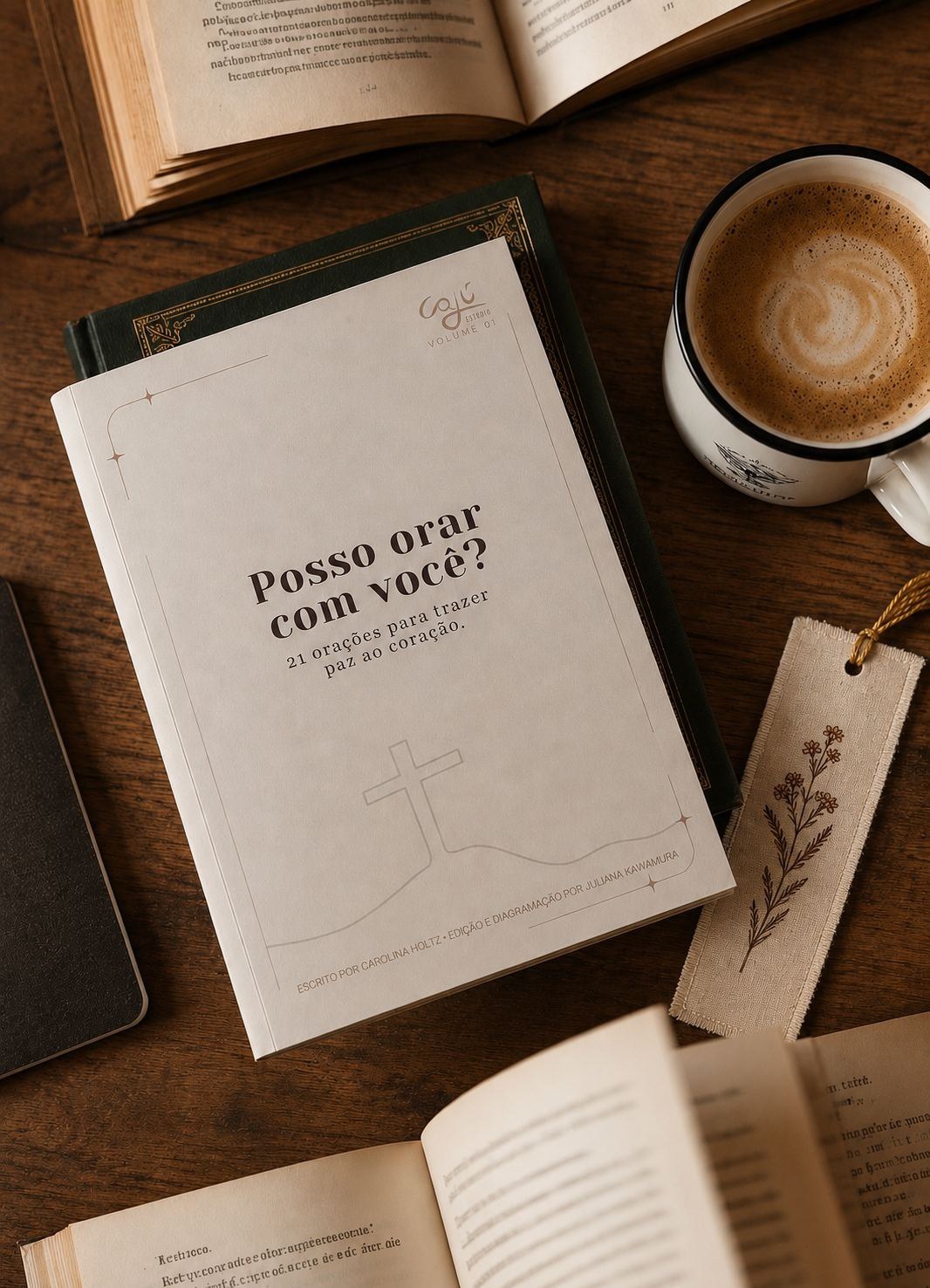 E-book Posso orar com você? sobre mesa de madeira, entre livros antigos e um café